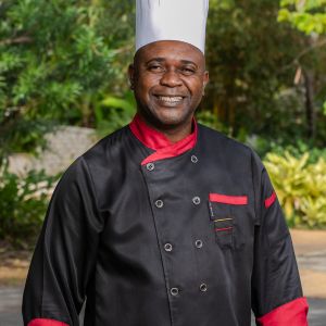 Rudolph Scotty Bailey in a black and red sous chef's uniform