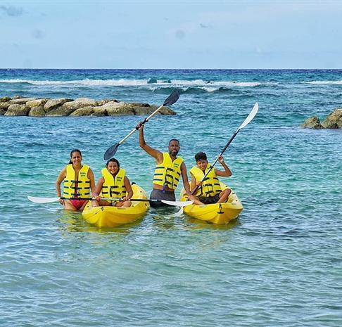 A group of people in yellow kayaks in the water