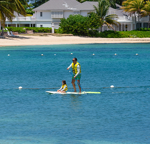A group of people in yellow kayaks in the water