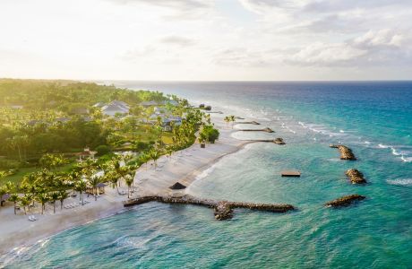 A beach with buildings and a pool