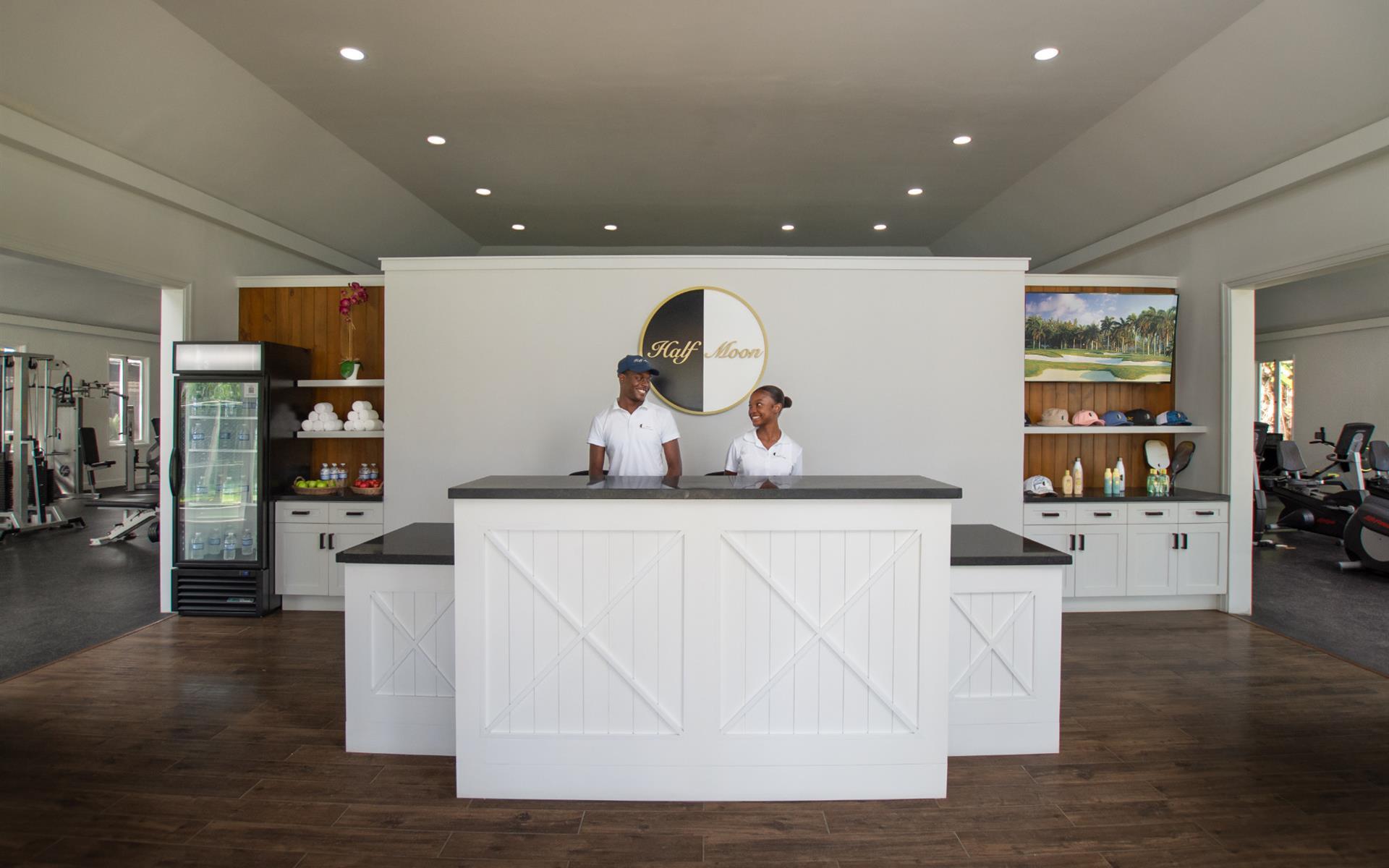 A man and woman standing at a reception desk