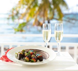 A plate of food and two glasses of champagne