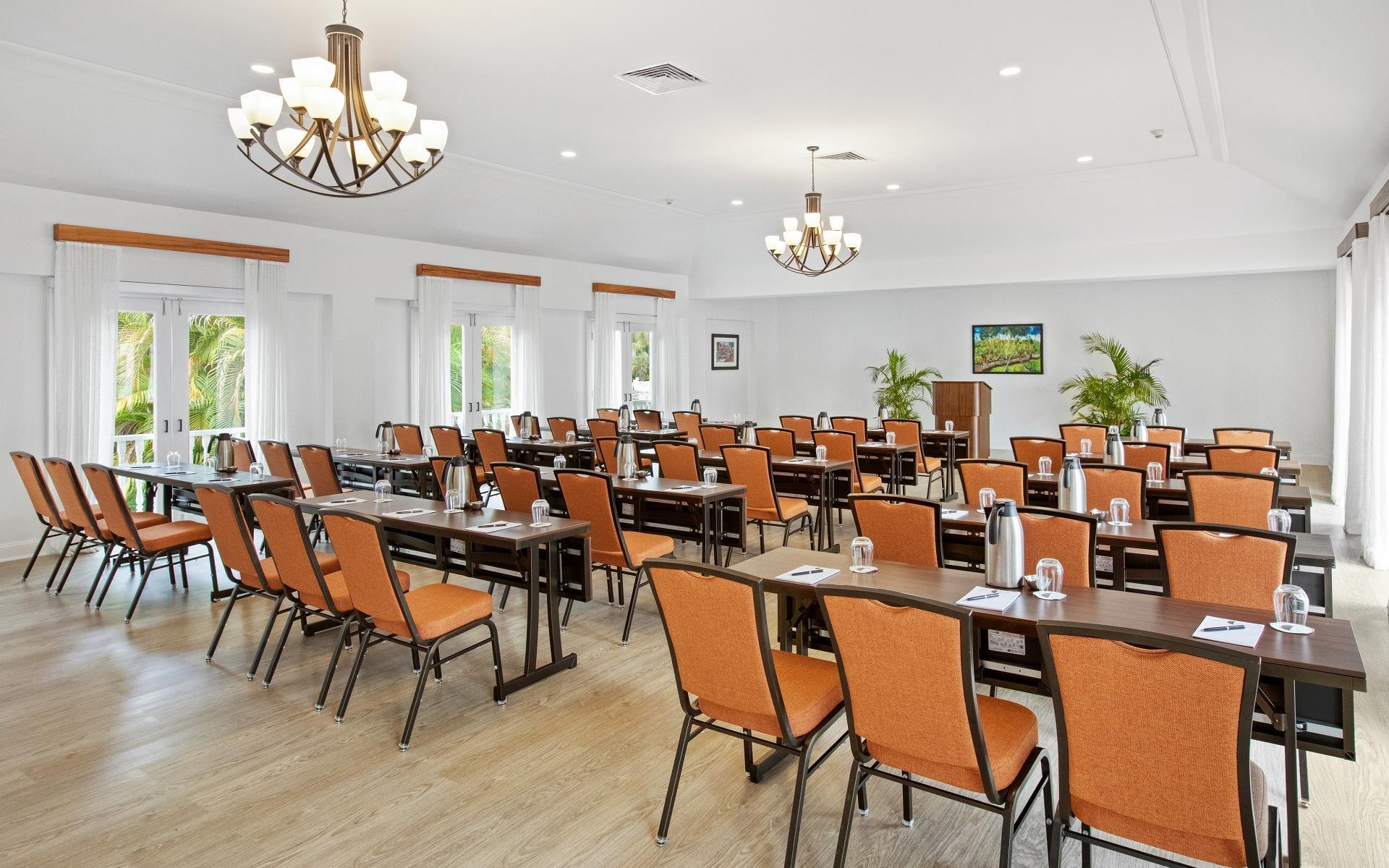 A room with chairs and a beige wooden floor