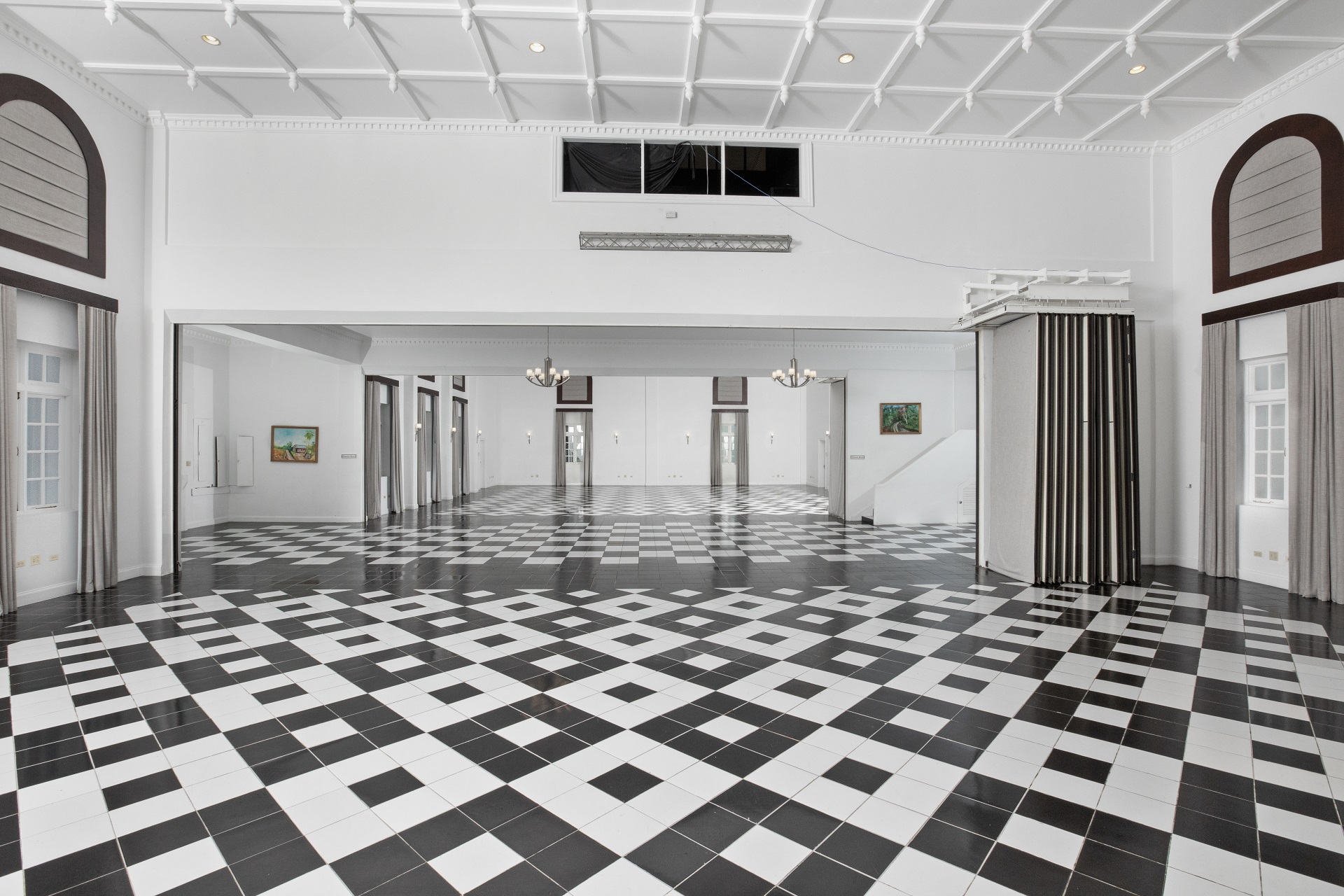 A room black and white tiles and a stage