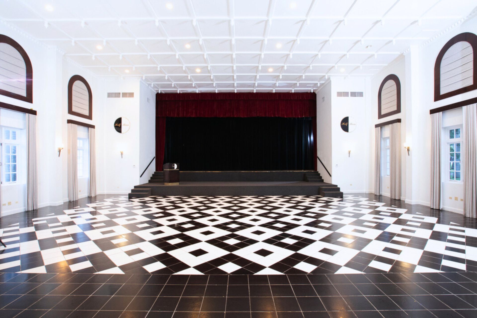 A room black and white tiles and a stage