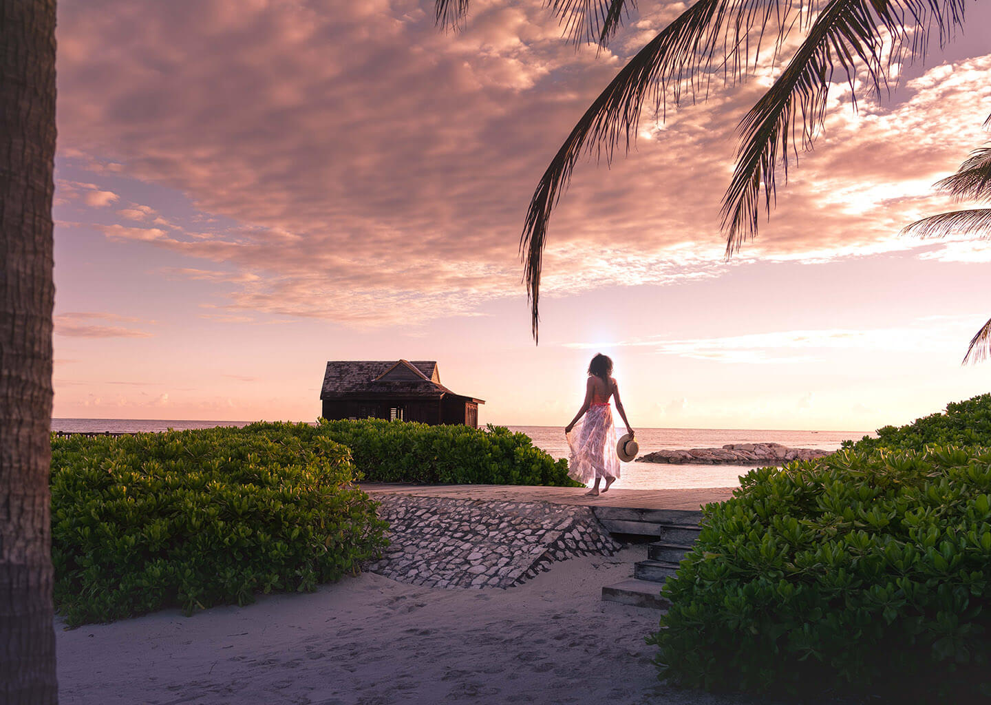 Woman taking a cabana walk at sunset
