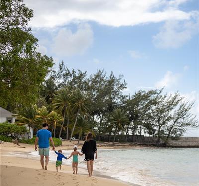 family holding hands for a walk on the beach