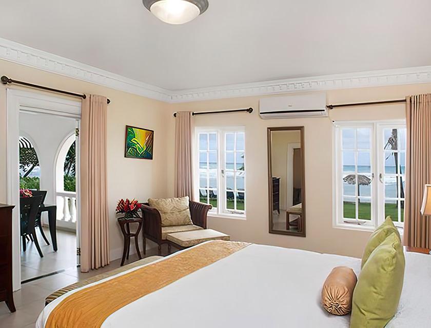 A room with a bed and chairs