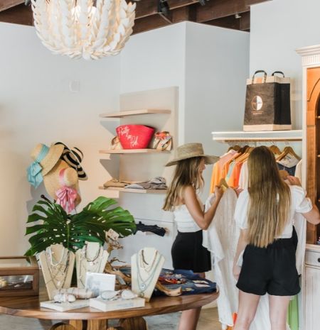 two women shopping in a clothing store