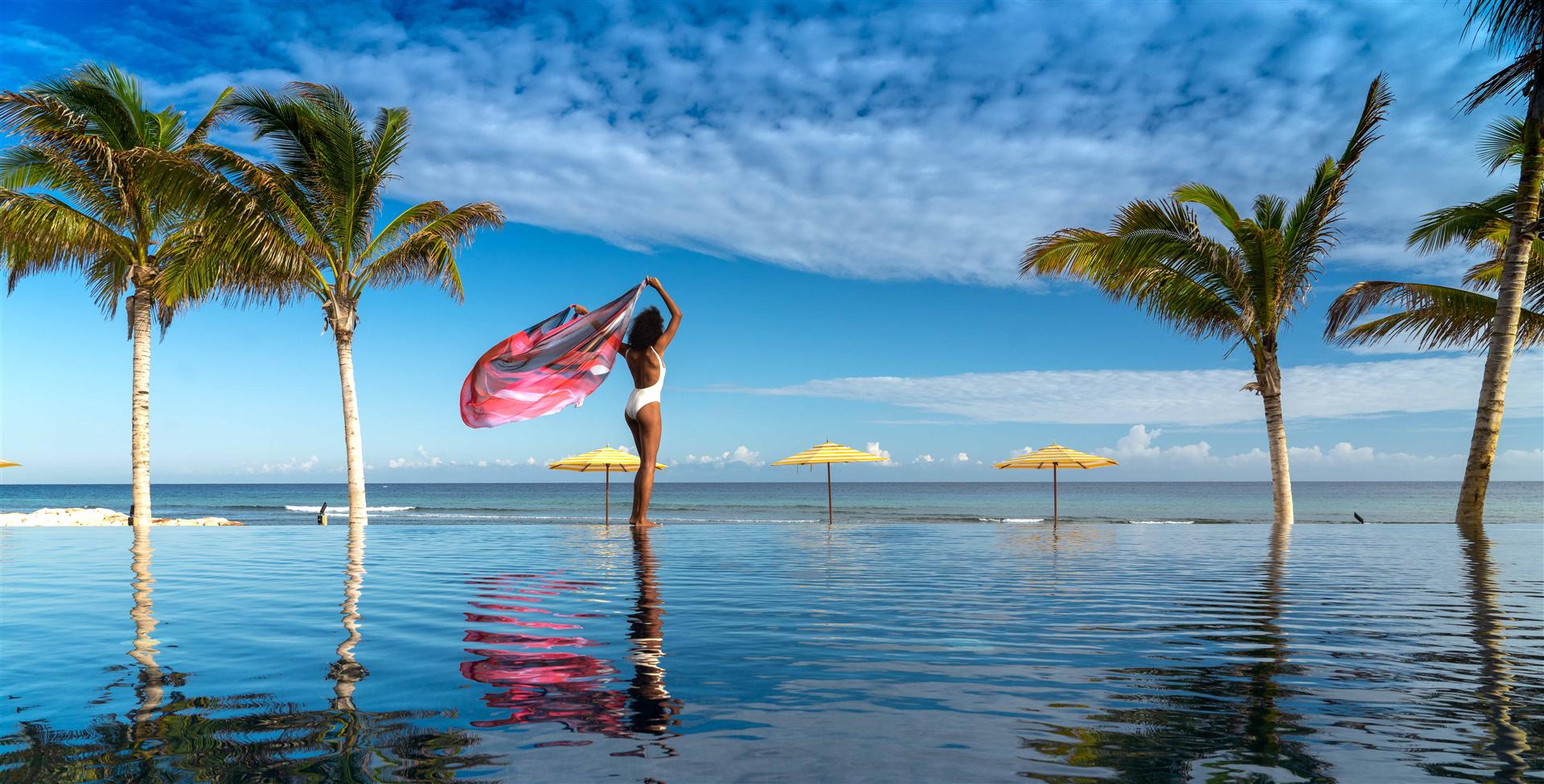 A woman standing in a pool with a towel