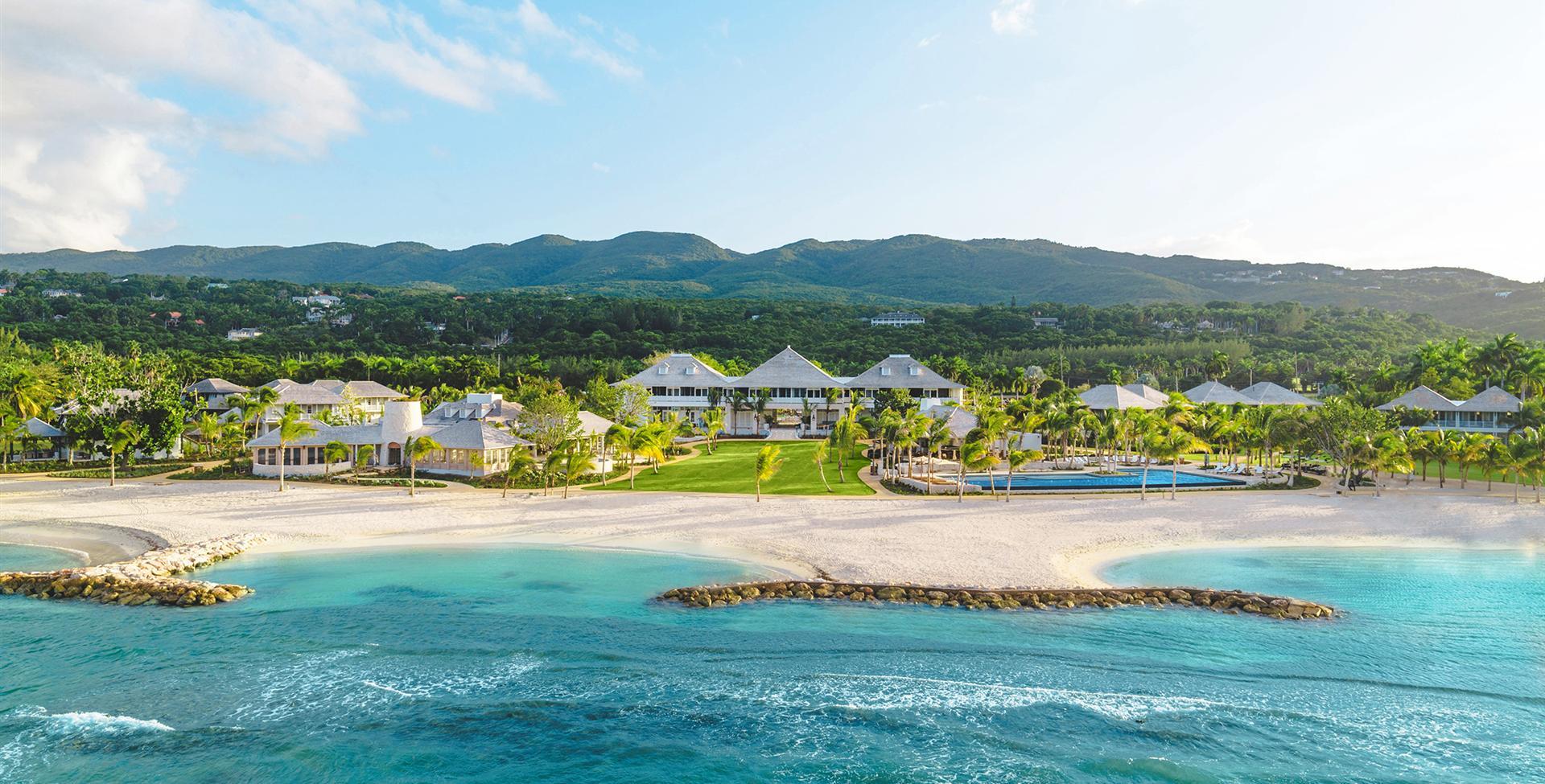 a beach with houses and a body of water