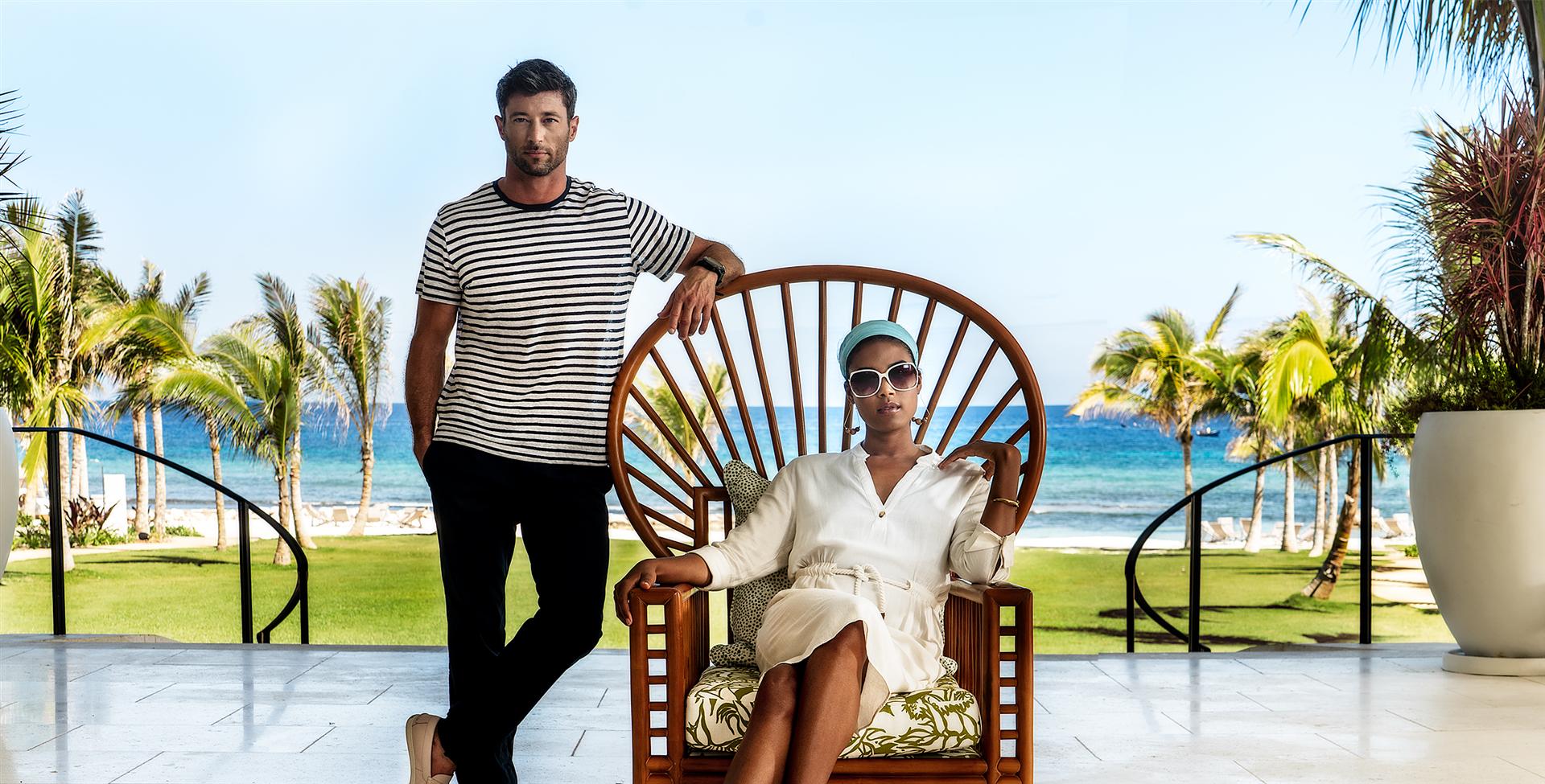 A couple sitting comfortably on a chair, taking in the serene view.