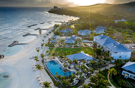 A beach with buildings and a pool