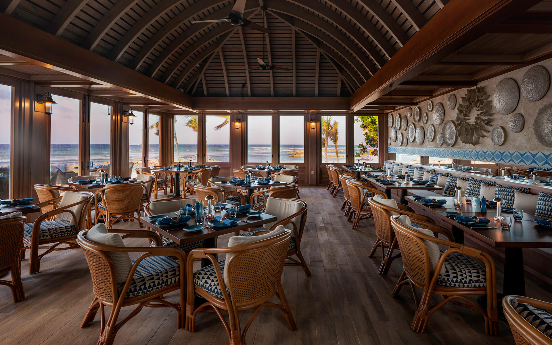 A room with tables and chairs and a large window